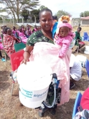 RipplAffect Samburu Loosuk Lesimirdana - Kenya - mother with child plus girls in the distance