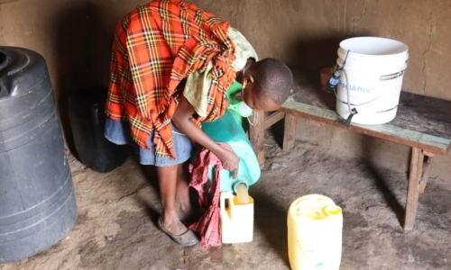 RipplAffect Samburu - woman in her home with bucket