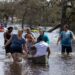 Florida - people in water and kayaks after hurricane Ian