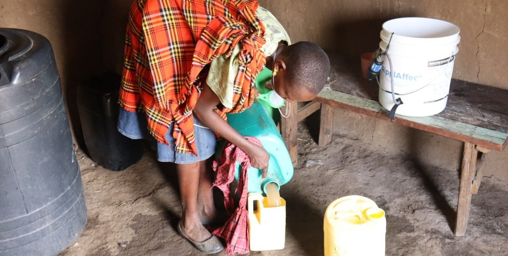 RipplAffect Samburu - woman in her home with bucket - Slider